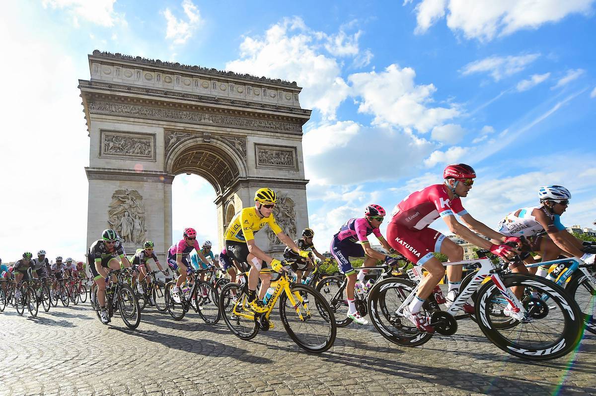 Tour de France cyclists racing through scenic countryside